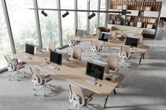 Top view of coworking interior with pc desktop and relax place near window